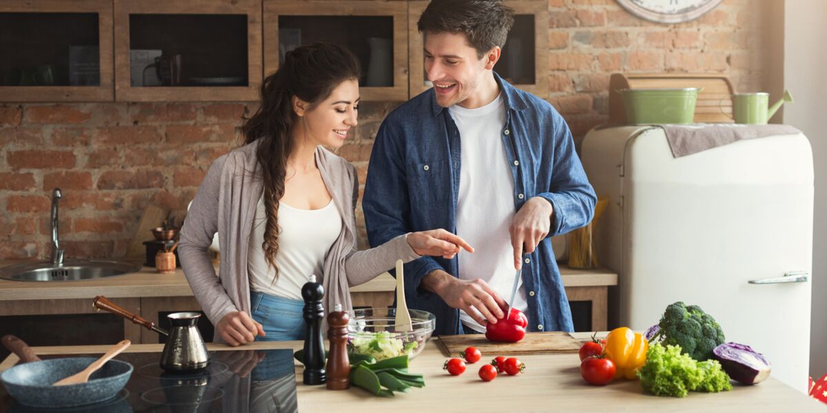 Happy couple cooking dinner together