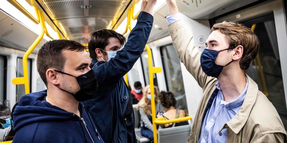 People wear mask on a metro train in Copenhagen shortly after midnigh