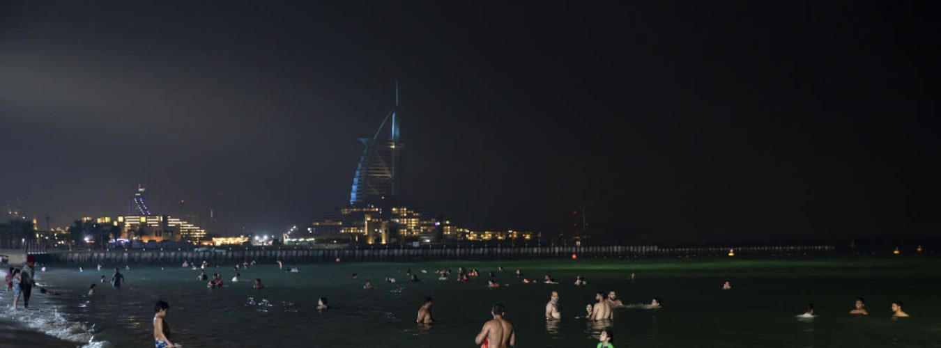 Swimmers at Umm Suqeim night swimming beach in Dubai, United Arab Emirates, on July 30, 2023. (Andrea DiCenzo/The New York Times)