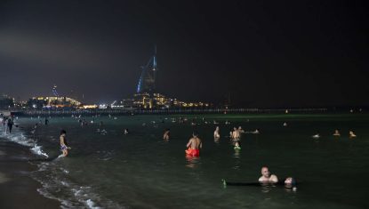 Swimmers at Umm Suqeim night swimming beach in Dubai, United Arab Emirates, on July 30, 2023. (Andrea DiCenzo/The New York Times)