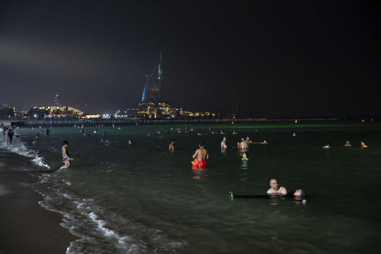 Swimmers at Umm Suqeim night swimming beach in Dubai, United Arab Emirates, on July 30, 2023. (Andrea DiCenzo/The New York Times)